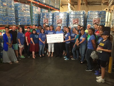 Movement Mortgage team members present a check for $150,000 in addition to donating 400,000 bottles of water to the Phoenix Rescue Mission's Code Red campaign.