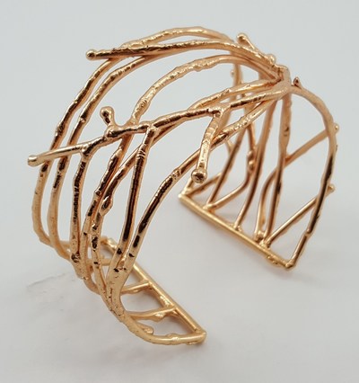 The adjustable 2 1/2" x 2 1/2" x 1 1/2" cuff is brass with gold-colored plating. Credit: Gifts With a Cause