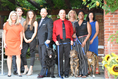 Saving America's Vets and America's Pets: American Humane President and CEO Dr. Robin Ganzert (left) introduces members of the first graduating class in American Humane's "Shelter to Service" program. The program rescues shelter dogs and specially trains them to become lifesaving service animals for military veterans in need.