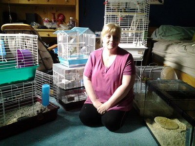 Melanie Gillis, an employee at Total Pet 100 Mile House store, is temporarily fostering dozens of small animal pets from the store in her home. The store was evacuated on July 9 due to the wildfires. (CNW Group/Pet Valu Inc.)