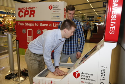 Cardiac arrest survivor Sean Ferguson practices Hands-Only CPR on a training kiosk at Indianapolis International Airport in 2016 with friend Matt Lickenbrock. Lickenbrock learned Hands-Only CPR at the training kiosk at DFW International Airport in April 2015. Days later, he performed Hands-Only CPR on Ferguson after he was struck by lightning in a parking lot at the University of Dayton.