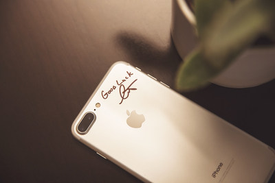The iPhone is ready to make its journey across the world. Curt Richardson, founder and Chief Visionary Officer of OtterBox, signed the phone just before handing it off to Nate Jestes for its first leg of the journey.