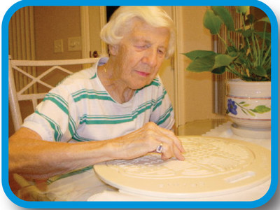 Senior Woman tracing a Brainpaths device to stimulate the brain and strengthen synapse neuron connections.