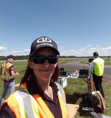 Jocelyne Bois, Microdrones’ Flight Operations Manager, smiles at the successful series of ten BVLOS flights she and her team achieved in Alma, Quebec on July 13 and 14. Bois, Microdrones’ Research and Development Engineer Jeremy Jung, and Microdrones’ UAV Pilot Yannick Savey completed these flights with a variety of payloads attached to an md4-1000 unmanned aerial vehicle, one of the few aircraft included on Transport Canada’s exclusive list of Compliant Unmanned Air Vehicles.