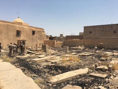 Soldiers take stock of the desecration done to a Catholic cemetery by ISIS in Karamdes, Iraq.