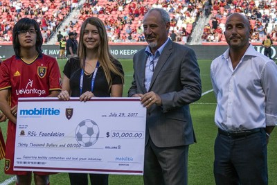 Joining with the RSL Foundation to help build futsal courts in Salt Lake City, Mobilitie formally presented its contribution of $30,000 during halftime of Real Salt Lake’s recent match against the Columbus Crew. Attending the presentation were (L-R) Bronson Roach- RSL Special Olympics Athlete; Keri Hale, RSL Foundation Board Member; Brian Filiss, Mobilitie’s VP-Wireless; and Ziad Khoury, Director -Wireless for Mobilitie.