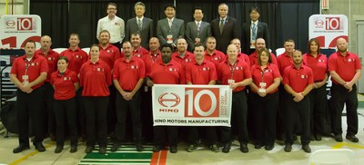 Hino Management, local West Virginia representatives and Hino Motors Manufacturing personnel celebrate their 10-year anniversary of manufacturing Hino's medium duty trucks. (PRNewsfoto/Hino Trucks)