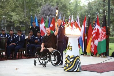 Retired MCpl. Jody Mitic, 20-year Canadian veteran and official ambassador of the Invictus Games Toronto 2017, lifts Invictus Spirit Flame in lighting ceremony in Kabul, Afghanistan. Photo Credit: Tahmina Saleem (CNW Group/Invictus Games Toronto 2017)