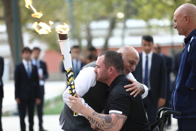 Afghanistan President Ashraf Ghani embraces retired Canadian MCpl Jody Mitic following the lighting of the Invictus Spirit Flame in Kabul today.  To the right, wounded Afghan veteran retired Maj Ahmad Shah. Photo Credit: Jawad Jalali European Press Agency (CNW Group/Invictus Games Toronto 2017)