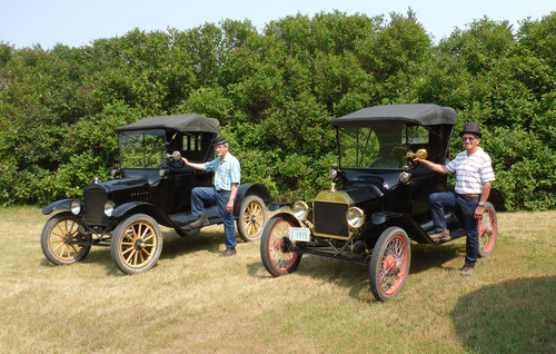 Brothers Bill (left) and Jim (right) Ewert with two of their Model T Roadsters, selling on August 19 in Drake, SK. (CNW Group/Ritchie Bros.)