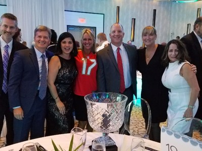 HomeBanc team members with BusinessWoman of the Year in her Tampa Bay Buccaneers jersey