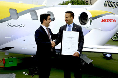 Roberto Honorato, the Superintendent of Department of Airworthiness, National Civil Aviation Agency - Brazil, presents the type certificate to HACI.