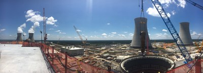 A panoramic view of a 1.4 million-pound Unit 3 steam generator being lifted into place at the Vogtle nuclear expansion near Waynesboro, Georgia. The cooling towers for the operational Vogtle Units 1 & 2, as well as the new Units 3 & 4, are in the background.