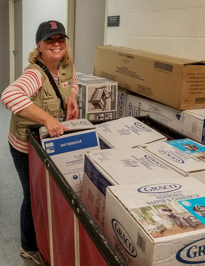 Jeanne-Aimee De Marrais, Save the Children’s senior director for U.S. emergencies, wheels a load of portable cribs for babies into a Salvation Army shelter for homeless families impacted by Hurricane Harvey in Texas. Save the Children photo.