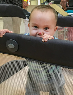 Nine-month-old Malachi peeks over the side of his new pack-and-play crib donated by Save the Children. The family is staying in a hurricane shelter in San Antonio, Texas. Malachi's mother Katrina said, 