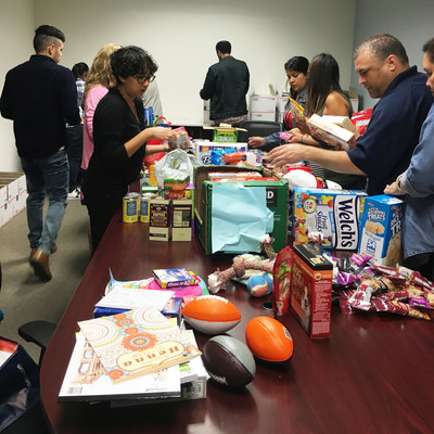 Carrington Mortgage Services Associates making care packages to send to active U.S. servicemembers deployed around the world as part of The Carrington Charitable Foundation's “Boxes for Our Troops Challenge.”