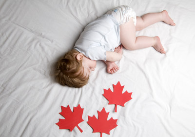 Canadian Baby, a young baby sleeping with Maple Leaves scattered around him. (CNW Group/Douglas by NOVOSBED)