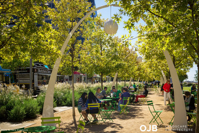 The oak grove and chandeliers establish a strong architectural rhythm and buffer the interior of Klyde Warren Park from the adjacent streets. The shady grove offers flexibility, allowing people to promenade throughout the park, socialize, people watch, or have a snack.