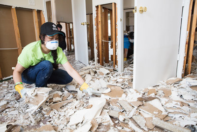 Habitat for Humanity volunteer Mali Mahnee helps clean out homes flooded by Hurricane Harvey in northeast Houston in preparation for repairs.