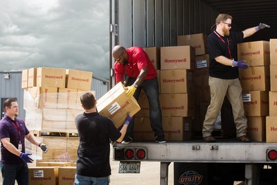 Honeywell employees unload safety equipment for immediate delivery to first responders and emergency personnel to support humanitarian relief efforts in Houston after Hurricane Harvey.