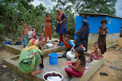 Des femmes et des enfants sont rassembls  une pompe  eau afin de se laver, de faire la lessive et de puiser de l'eau potable au camp de fortune Kutupalong pour personnes rfugies rohingyas  Ukhiya, un sous-district de Cox's Bazar, au Bangladesh.  UNICEF/UN069113/Noorani (Groupe CNW/UNICEF Canada)