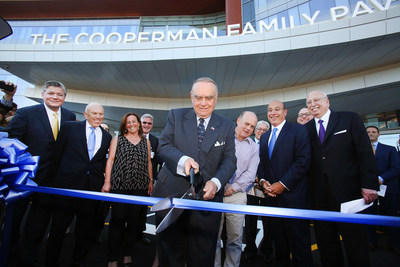 Pictured at the Cooperman Family Pavilion Ribbon Cutting are (L-R) Stephen P. Zieniewicz, FACHE, President and CEO, Saint Barnabas Medical Center; Bruce Schonbraun, Chairman, Board of Trustees; Saint Barnabas Medical Center; Jodi Cooperman; Leon Cooperman, Benefactor, (cutting the ribbon); Wayne Cooperman; Barry H. Ostrowsky, President and Chief Executive Officer, RWJBarnabas Health; and Richard J. Kogan, Chairman Emeritus, Board of Trustees, Saint Barnabas Medical Center.