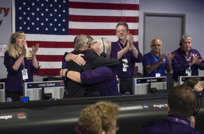 Earl Maize, program manager for NASA’s Cassini spacecraft at the agency’s Jet Propulsion Lab, and Julie Webster, spacecraft operations team manager for the Cassini mission at Saturn, embrace in an emotional moment for the entire Cassini team after the spacecraft plunged into Saturn, Friday, Sept. 15, 2017. Credit: NASA