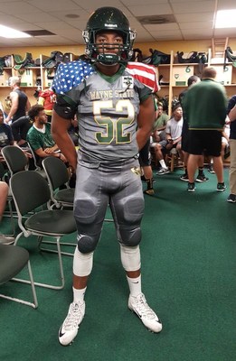 Anthony Pittman, linebacker for the Wayne State University football team, displays the jerseys the team will wear to honor Medal of Honor recipients.