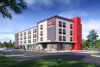 The modern exterior design of avid hotels includes an open and airy retail-like entry, a canopy and uses the stairwell as an eye catching red architectural feature.