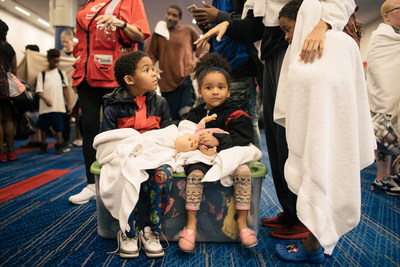 Dayvon Williams, 5, Zariah Williams, 4, wait to check in at the temporary shelter at the George R. Brown Convention Center in downtown Houston. Shown with donated Standard Textile towels. (c) Alyssa Schukar