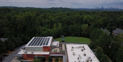 With the city of Atlanta in the background, Cliff Valley School's gymnasium roof is covered with solar panels.