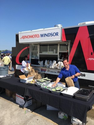 Brad Kumin (Ajinomoto Windsor VP of Marketing: Foodservice) and Debbie Grudzien (Ajonomoto Windsor SW Division Manager) preparing bagged lunches for victims.