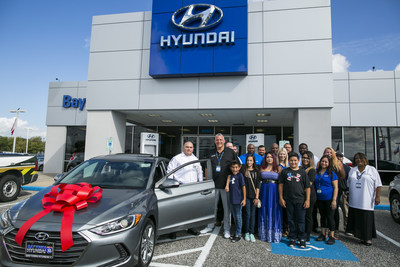 BAYTOWN, TX - SEPTEMBER 25: Henry Rogers (left) poses with his family and members of Baytown Hyundai after receiving a 2018 Hyundai Elantra September 25, 2017 in Baytown, TX.  Henry Rogers was given the car for being an extraordinary first responder during Hurricane Harvey.  (Photo by Drew Anthony Smith/Getty Images)