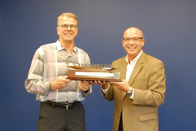 President and CEO of Botaneco, James Szarko (left), presents Acme-Hardesty president, Jeff Kenton, with a gift to commemorate the start of their partnership. The “Team of Rowers” symbolizes the common vision and unified values of the two companies.