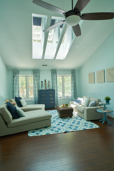 Lifestyle blogger, Designer Trapped, completed a bedroom transformation featuring skylights with navy blue blinds.