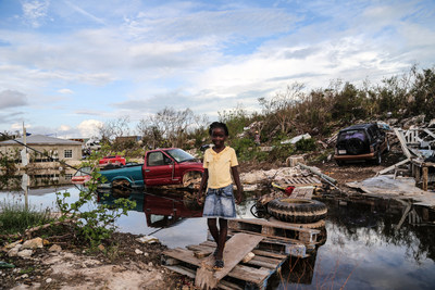 In the aftermath of Hurricane Irma, a young girl crosses an improvised wooden bridge which she built, in the Turks and Caicos Islands.  UNICEF/UN0122368/Moreno Gonzalez (CNW Group/UNICEF Canada)