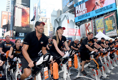 Henrik Lundqvist, goal keeper for the New York Rangers, rides with TAG Heuer at Cycle for Survival's Times Square Takeover to support the movement to beat rare cancers. At the event, TAG Heuer announced their sponsorship as the Official Timepiece and Official Timekeeper of Cycle for Survival. (Photo Credit: Diane Bondareff, Cycle for Survival)
