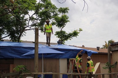 AmeriCorps members with the AmeriCorps Disaster Response Team responding to Hurricane Harvey in Texas assist a homeowner with temporary roof repairs. [Corporation for National and Community Service Photo]