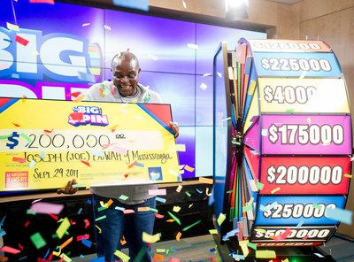 Joseph Buwah of Mississauga celebrates after spinning THE BIG SPIN Wheel at the OLG Prize Centre in Toronto to win $200,000. Buwah was the third person to win a top prize with OLG’s new INSTANT game – THE BIG SPIN. (CNW Group/OLG)