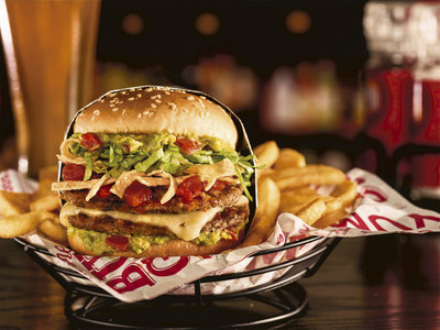 Red Robin's Taco Tavern Double Burger features two fire-grilled beef patties, melted pepper jack cheese, crispy tortilla strips, fresh guacamole, zesty salsa and shredded lettuce on a sesame seed bun.