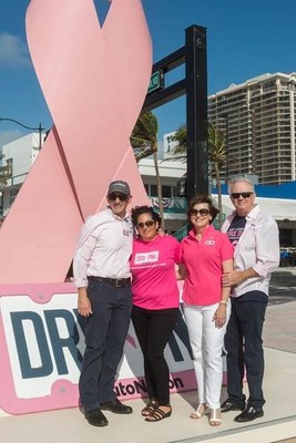 Breast Cancer Survivor and AutoNation Associate (second from left) Karen Gelfer is joined by Marc Cannon, Executive Vice President and Alice and Mike Jackson, Chairman, CEO and President to launch AutoNation’s Drive Pink Initiative in front of a 20 foot pink ribbon. (PRNewsfoto/AutoNation, Inc.)