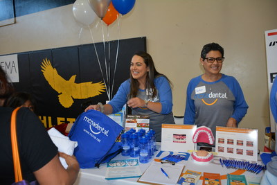 MCNA Dental employees distribute dental kits and backpacks to Houston-area residents