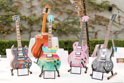 4 hand painted guitars signed by various celebrities were auctioned off to raise money for cancer research