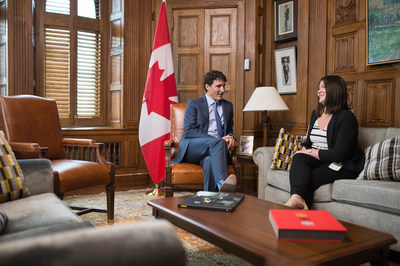 Prime Minister Justin Trudeau shares his office with Breanne Lavallée-Heckert, 23, on Oct. 5 as part of Plan International Canada’s #GirlsBelongHere initiative, which celebrates girls in positions of leadership and power leading up to International Day of the Girl. (CNW Group/Plan International Canada)