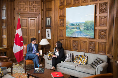 Prime Minister Justin Trudeau shares his office with Breanne Lavallée-Heckert, 23, on Oct. 5 as part of Plan International Canada’s #GirlsBelongHere initiative, which celebrates girls in positions of leadership and power leading up to International Day of the Girl. (CNW Group/Plan International Canada)