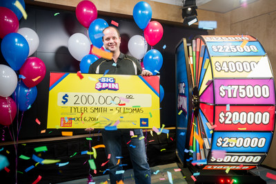 Tyler Smith of St. Thomas celebrates after spinning THE BIG SPIN Wheel at the OLG Prize Centre in Toronto to win $200,000. Smith was the fourth person to win a top prize with OLG’s new INSTANT game – THE BIG SPIN. (CNW Group/OLG Winners)