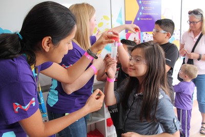 MilliporeSigma employees teach hands-on STEM lessons inside the Curiosity Cube™