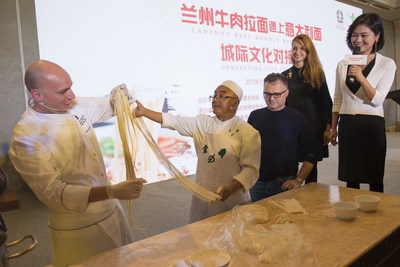 Chef De Cuisine Amedeo Ferri learns to make Lanzhou beef noodles with Chef Ma Wenbin (PRNewsfoto/Publicity Department of the CPC)