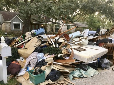 Mounds of destroyed property sit outside a damaged house after Hurricane Harvey.
