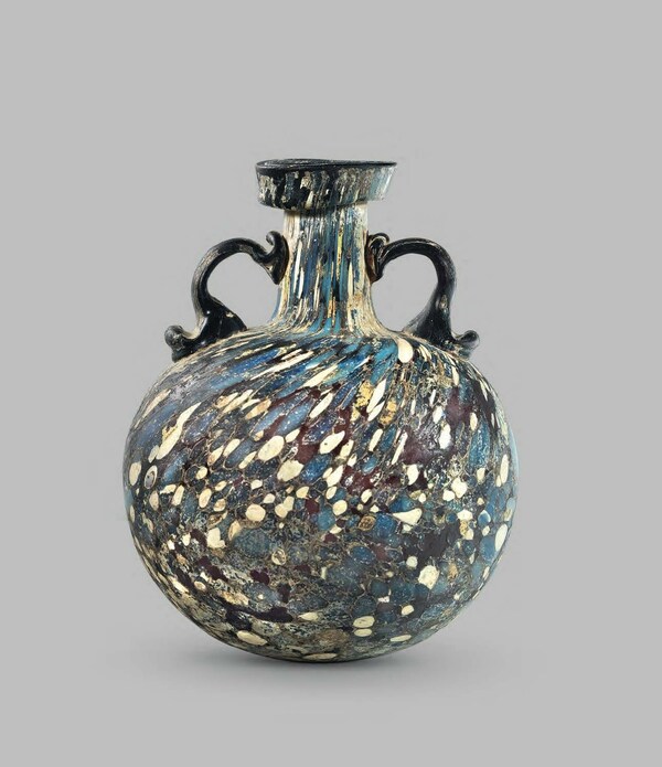 Roman, 1st century A.D.; Purple, yellow, blue and white glass; H: 16 cm (6.29 in) | PROVENANCE: Formerly, Benzian collection, Lucerne, Switzerland, prior to 1984; Sotheby's, London, 7 July 1994, Lot 134. | PUBLISHED: 3000 Jahre Glasskunst, Lucerne, 1981, p. 75, no. 235; KLEIN D. - LLOYD W. (eds.), The History of Glass, London, 1984, p. 27; Sotheby's, London, 7 July 1994, Lot 134.